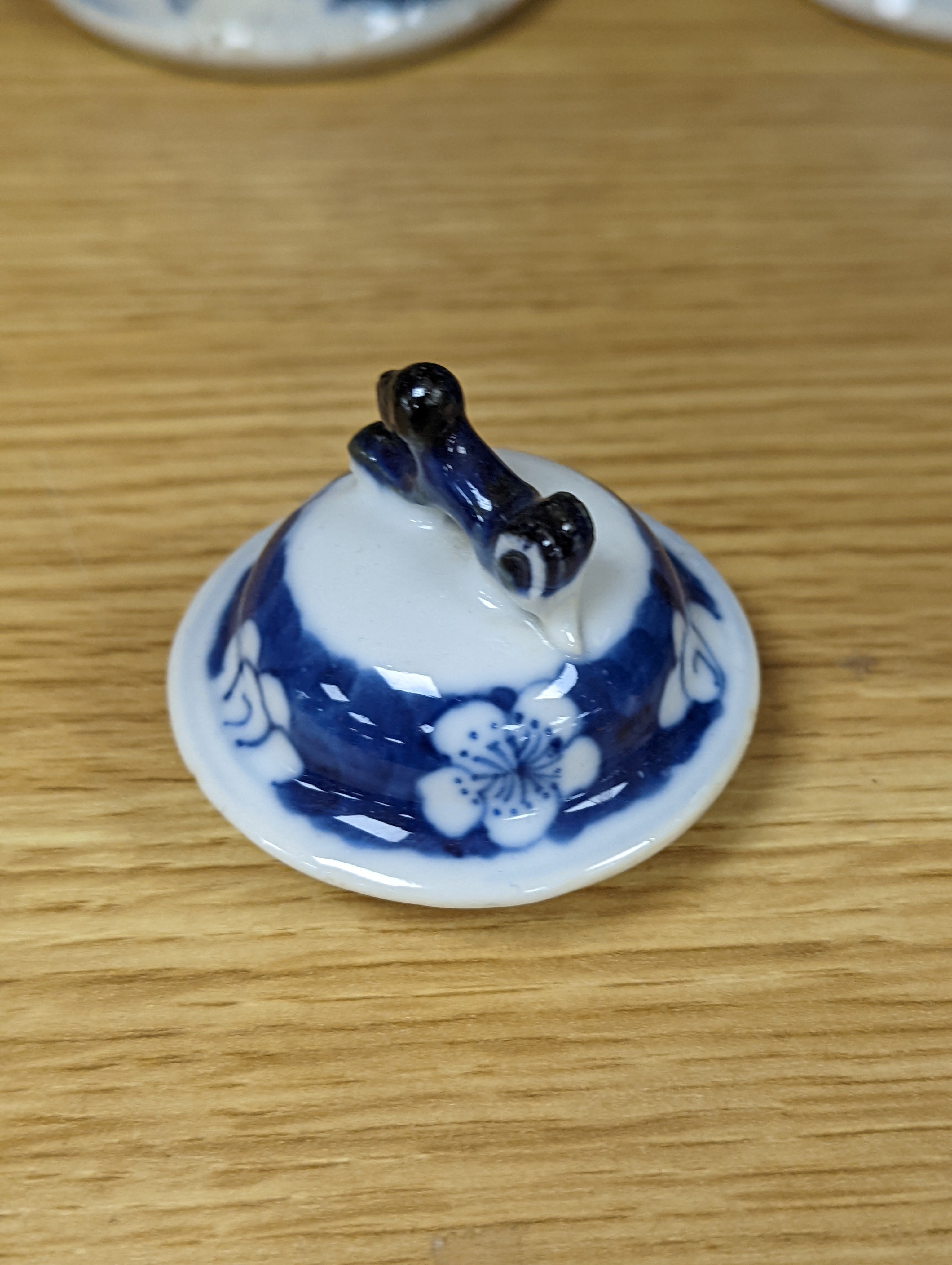 A pair of 19th century Chinese blue and white vases, a prunus vase and cover and a similar jar (4), pair of vases 24 cms high.